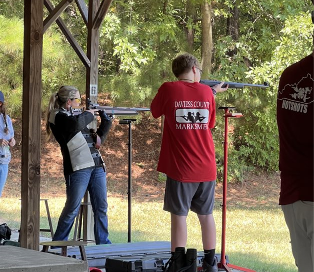 two teens shooting rifles