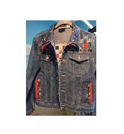 Picture of a denim jacket with added fabric pieces.