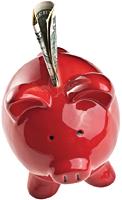 red piggy bank with money sticking out