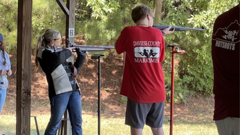 two teens shooting rifles